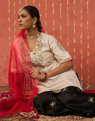 Ivory Roli Silk Embroidered Short Kurta And Sharara Set by Shivani Bhargava available on Indiaspopup.com