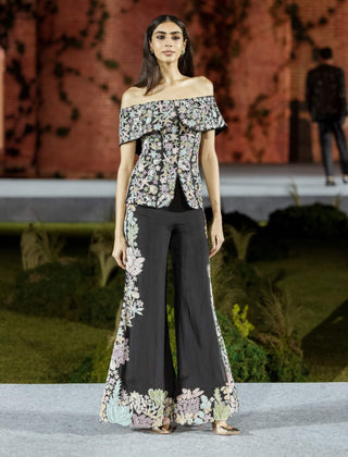 Black tyra pants and off-shoulder top