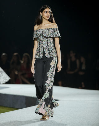 Black tyra pants and off-shoulder top