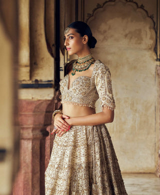 Gold Raw Silk Lehenga Choli Set by Nitika Gujral available on Indiaspopup.com