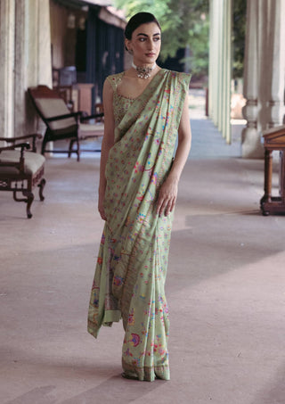 Green sari and embroidered blouse