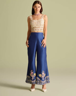 Ivory beadwork bustier with indigo jacket and pants