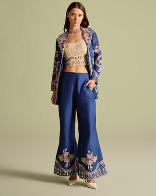 Ivory beadwork bustier with indigo jacket and pants