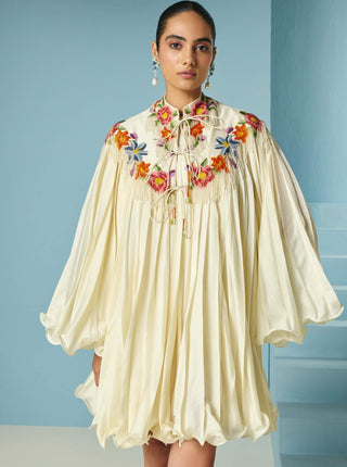 Ivory pleated dress with floral cape