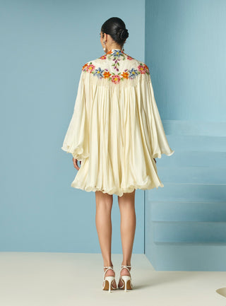 Ivory pleated dress with floral cape