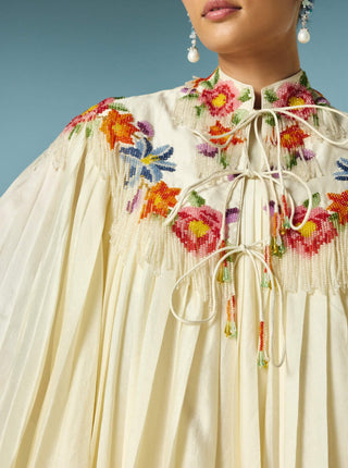 Ivory pleated dress with floral cape