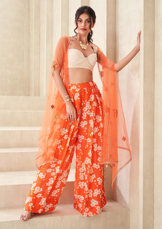 Orange printed pants with bustier and cape