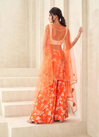 Orange printed pants with bustier and cape
