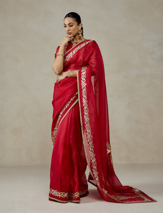 Red organza sari with brocade blouse
