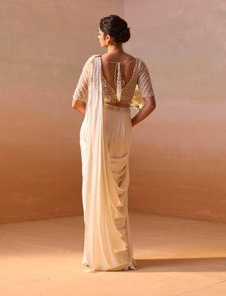 Ivory Satin Draped Sari And Blouse by Nitika Gujral, available on Indiaspopup.com