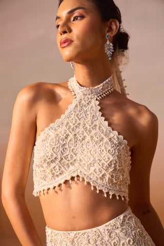 Ivory Fishtailed Skirt And Halter Blouse by Nitika Gujral, available on Indiaspopup.com