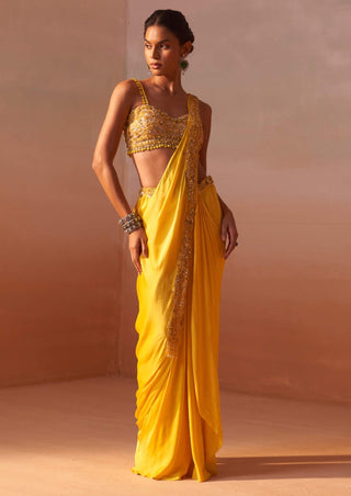 Yellow draped sari and nude choli