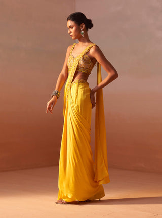 Yellow Draped Sari And Nude Choli by Nitika Gujral, available on Indiaspopup.com