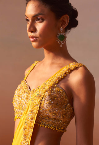 Yellow Draped Sari And Nude Choli by Nitika Gujral, available on Indiaspopup.com