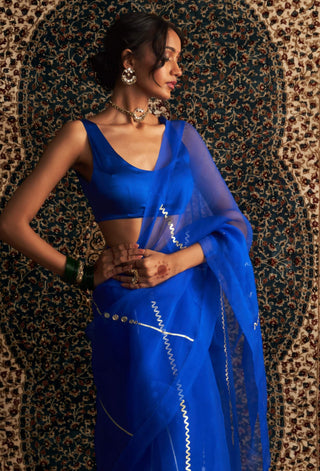 Blue embroidered organza sari and sleeveless blouse