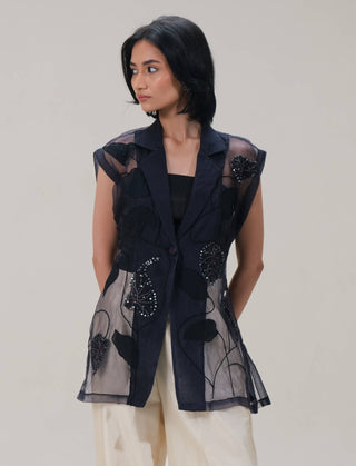 Lumière black shirt and beige pants