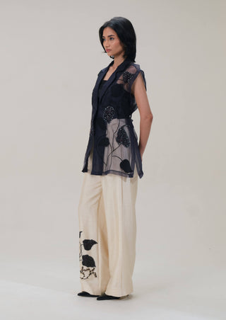 Lumière black shirt and beige pants