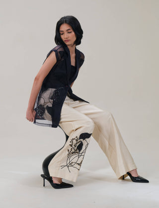 Lumière black shirt and beige pants