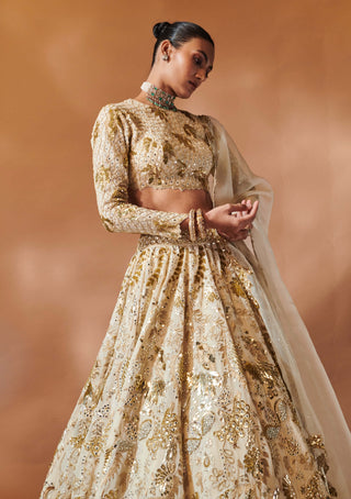 Ivory And Gold Heavily Embroidered Lehenga Set by Tamanna Punjabi Kapoor, available on Indiaspopup.com