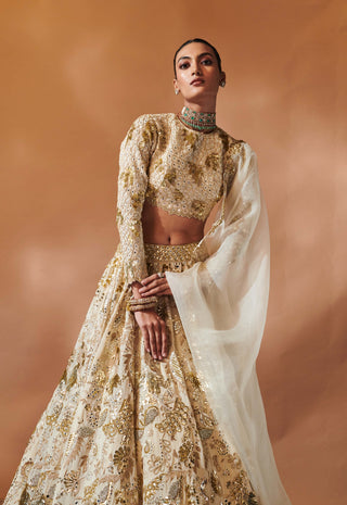 Ivory And Gold Heavily Embroidered Lehenga Set by Tamanna Punjabi Kapoor, available on Indiaspopup.com